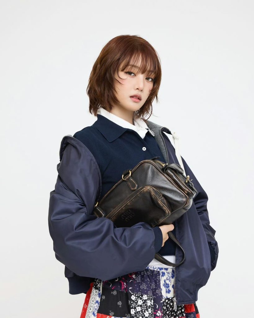 Navy-Quilted-Bomber-Jacket-with-Black-Crossbody-Bag-and-Flor